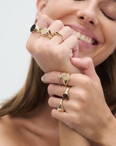 Woman wearing gold signet rings